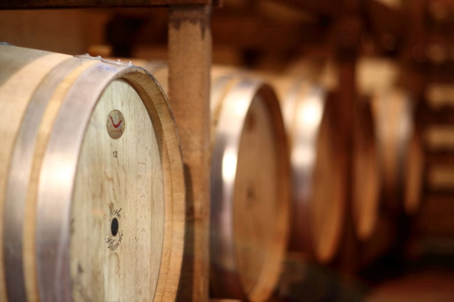 wine barrels on the wood panels on the both sides at Orealios Gaea cellar